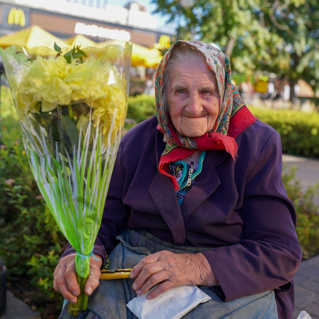 Happy senior woman holding a membership discount card