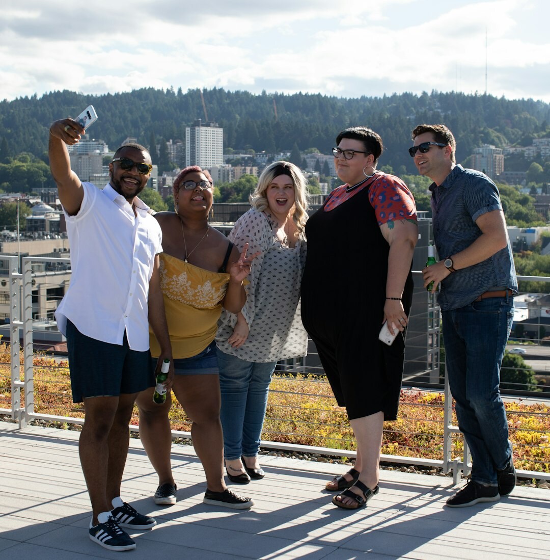 Diverse group of smiling seniors and staff standing together outdoors