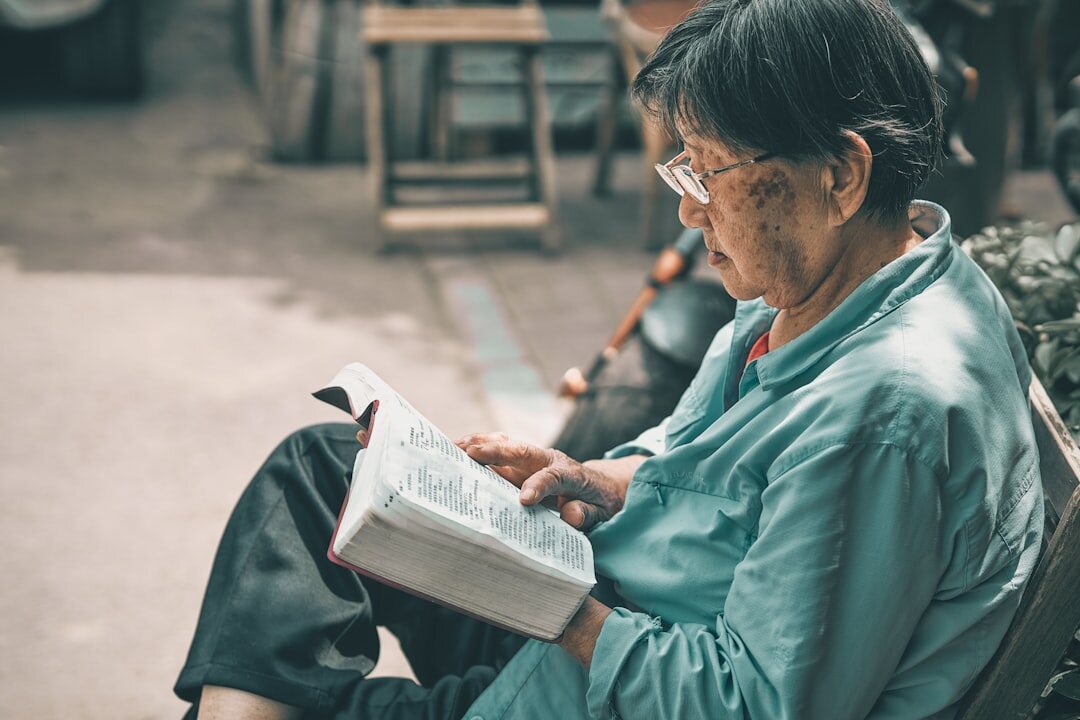 elderly woman reading book